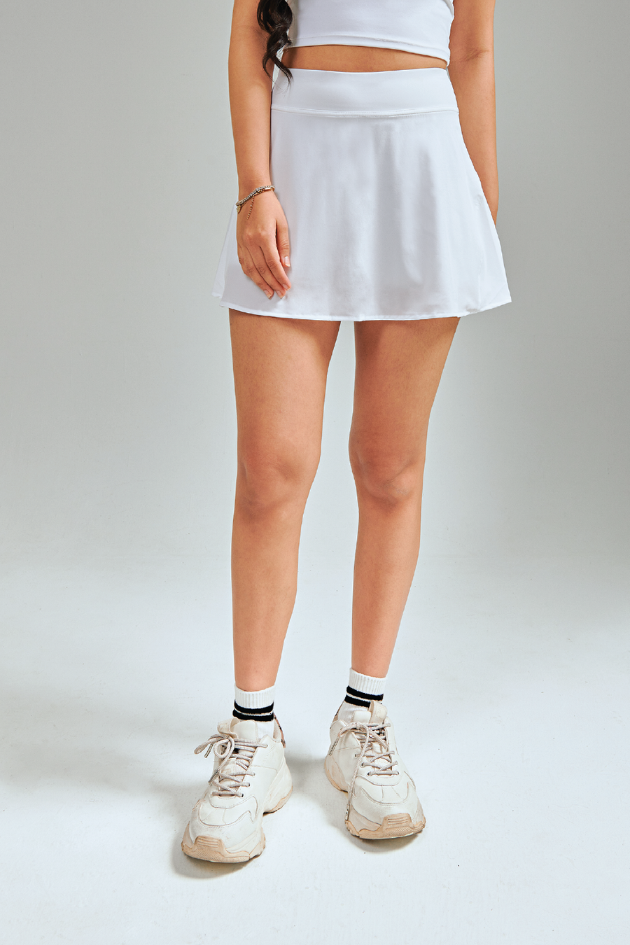 Mini length hem tennis skirts. Lightweight, breathable and comfortable. Featuring built in shorts and pockets for storage. White & Classic Tennis Skirt.